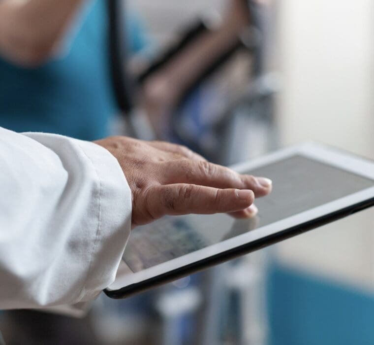 close up of a doctor working on an ipad
