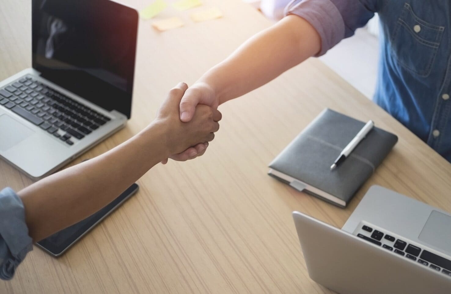 Close up of a handshake between a client and a service provider