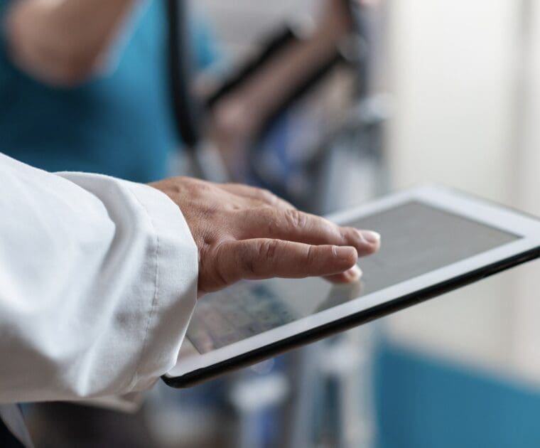 close up of a doctor working on an ipad